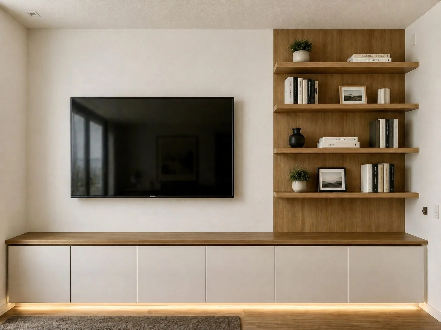 Living room built-in with pale doors, oak-toned open shelves, and lighting beneath the cabinets